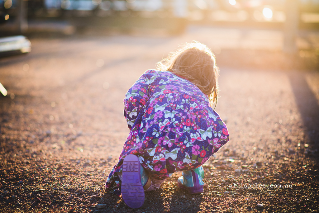 Girl in pink hunting for rocks