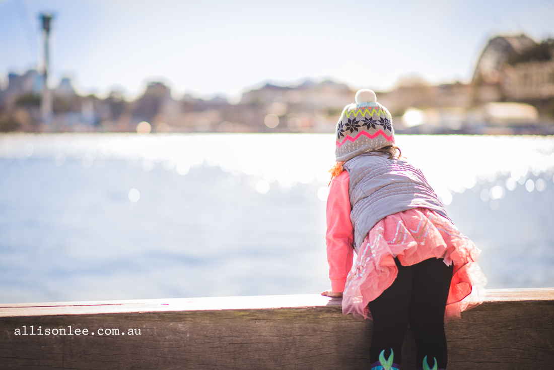 Four year old girl at harbour with Harbour Bridge