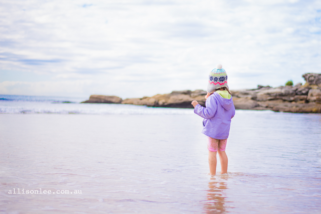 Four year old girl at Manly beach in winter