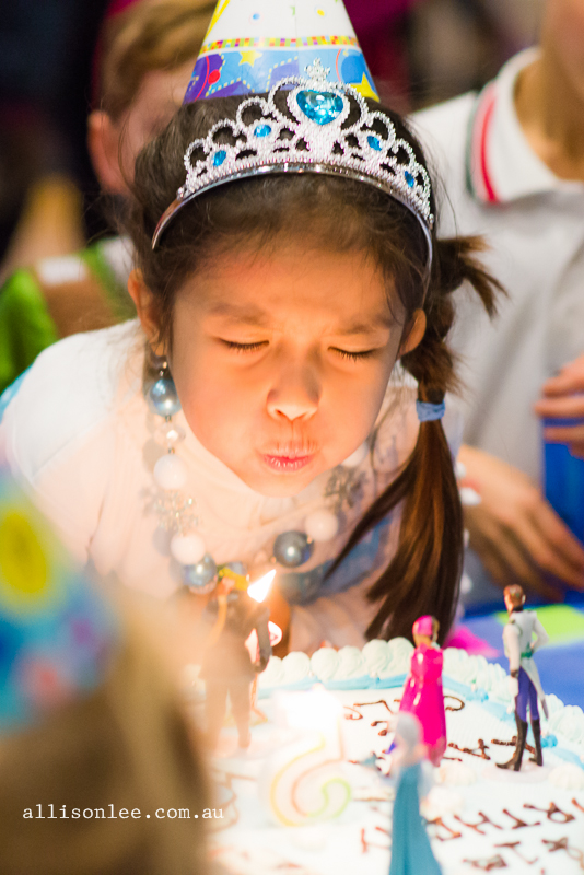 Birthday girl blowing out candles