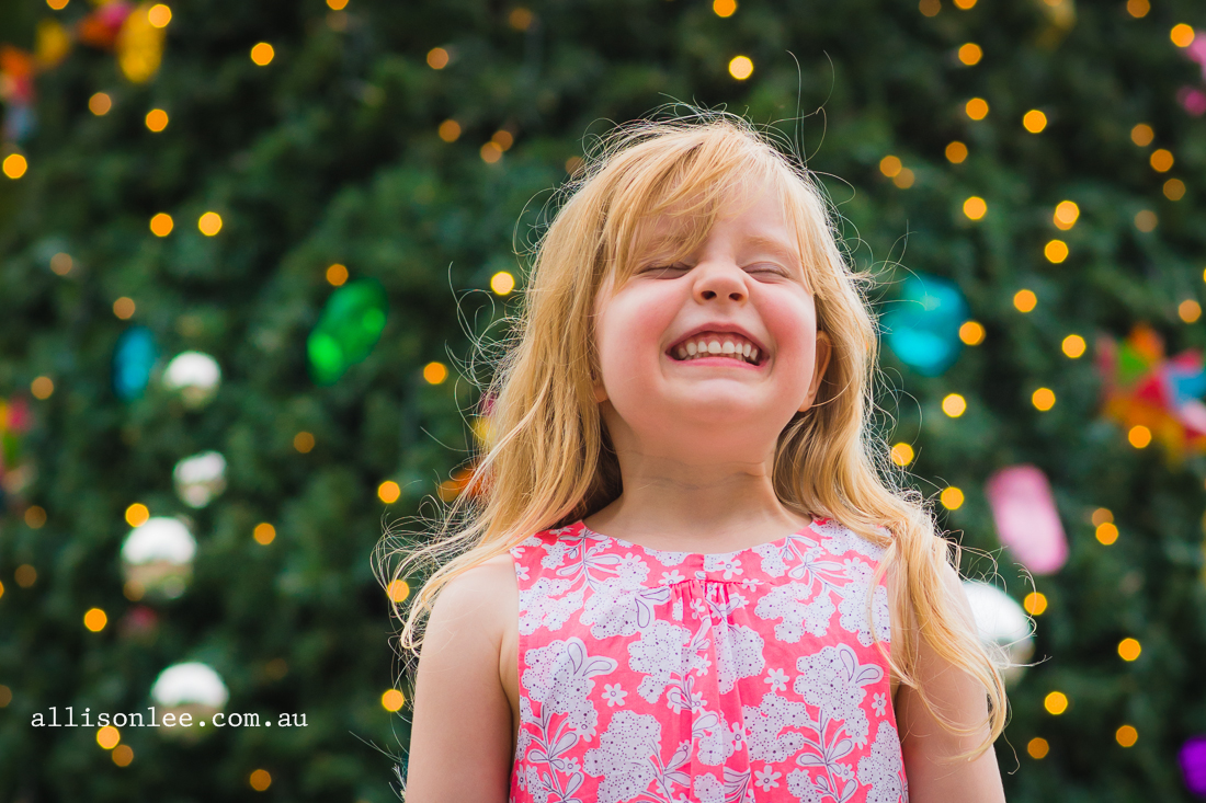 Blonde four year old in front of the Christmas tree in Pyrmont