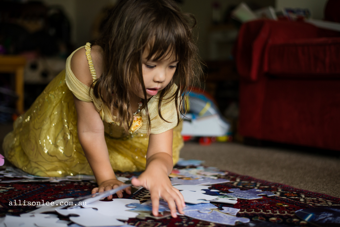 girl playing with Frozen puzzle