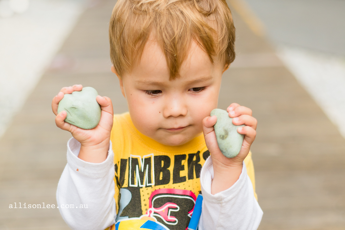 toddler boy playing with rocks