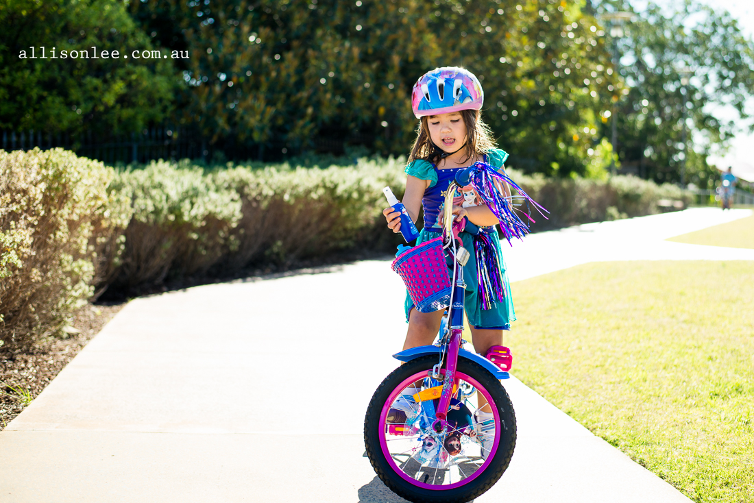 brown haired girl riding frozen bike