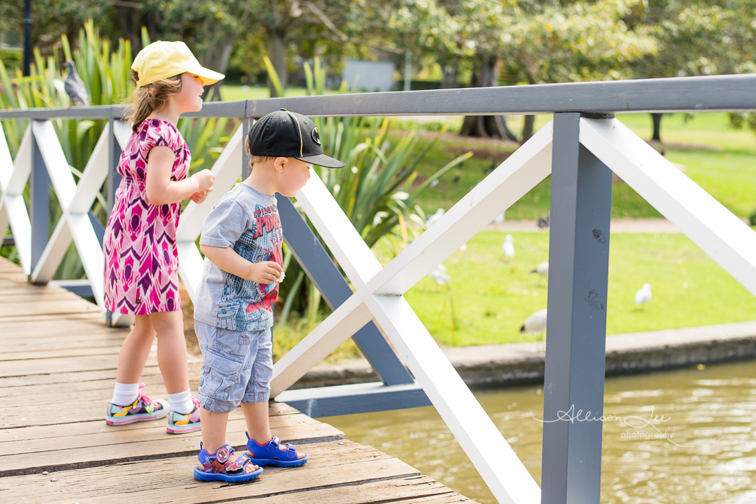 Siblings feeding ducks in Victoria Park